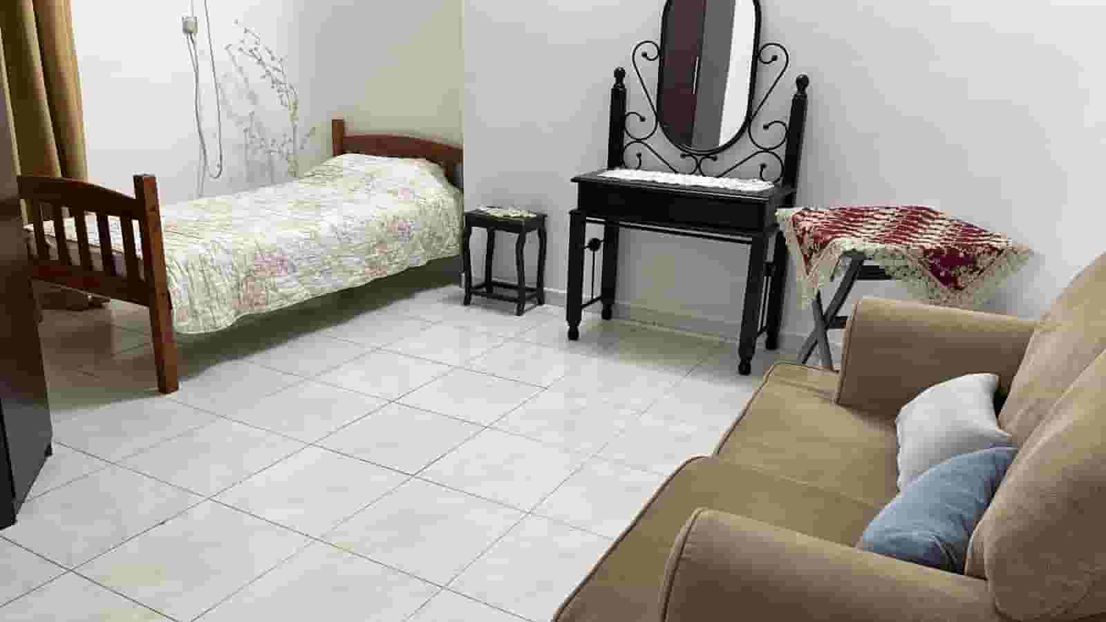 A separate furnished room with a refrigerator