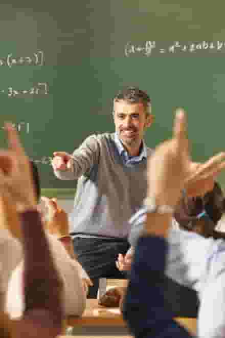 A teacher helps students with their projects and homework