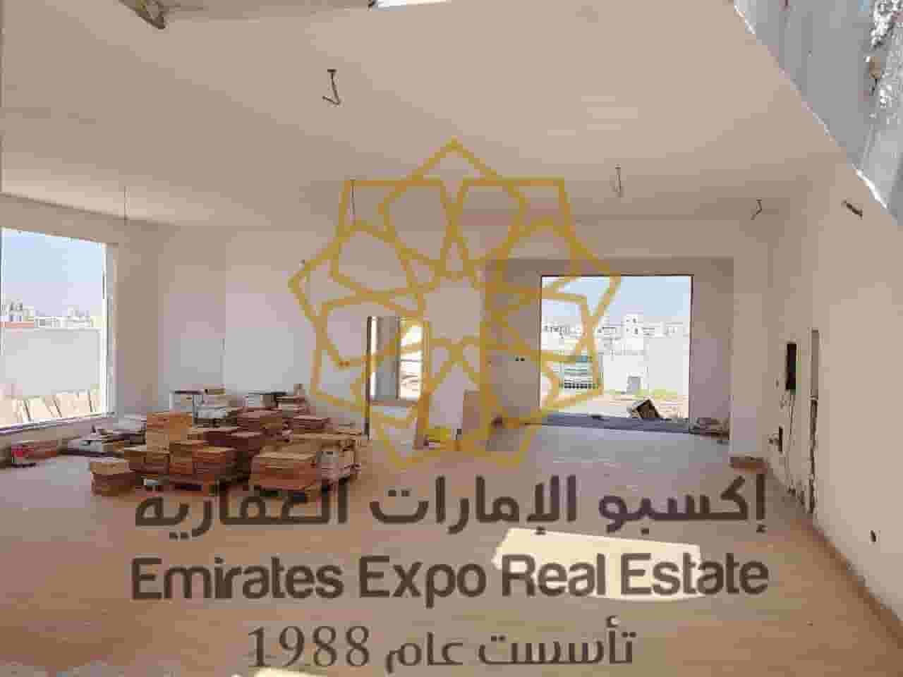 For sale, a new modern natural stone villa is under construction in Riyadh, south of Al Shamkha, with a percentage of about 85%