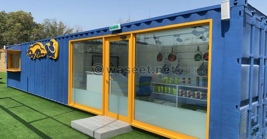 Container for sale, divided into two parts: a kitchen and a shower or indoor seating area 4