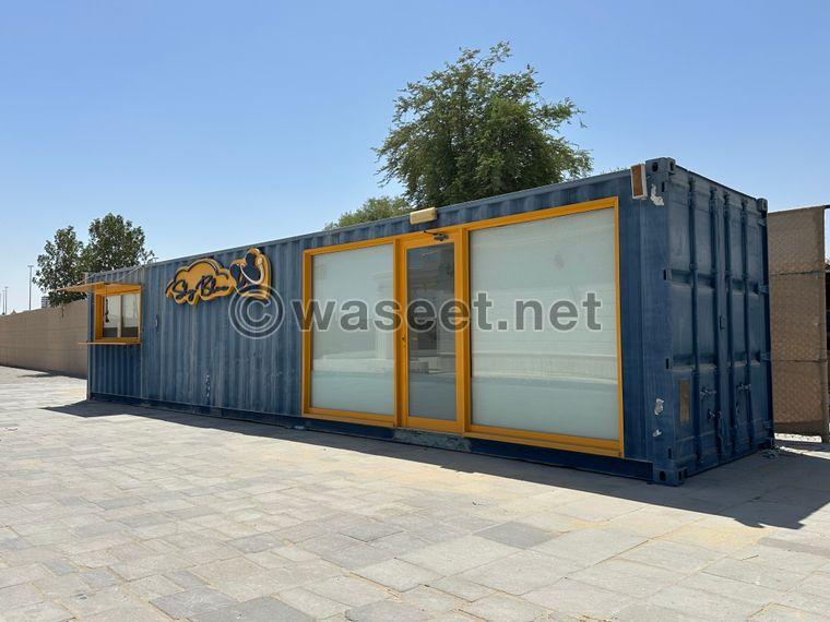 Container for sale, divided into two parts: a kitchen and a shower or indoor seating area 1