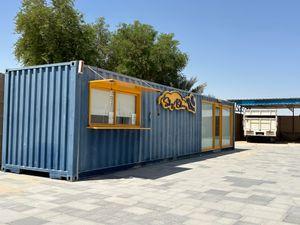 Container for sale, divided into two parts: a kitchen and a shower or indoor seating area