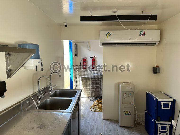 Container for sale, divided into two parts: a kitchen and a shower or indoor seating area 2