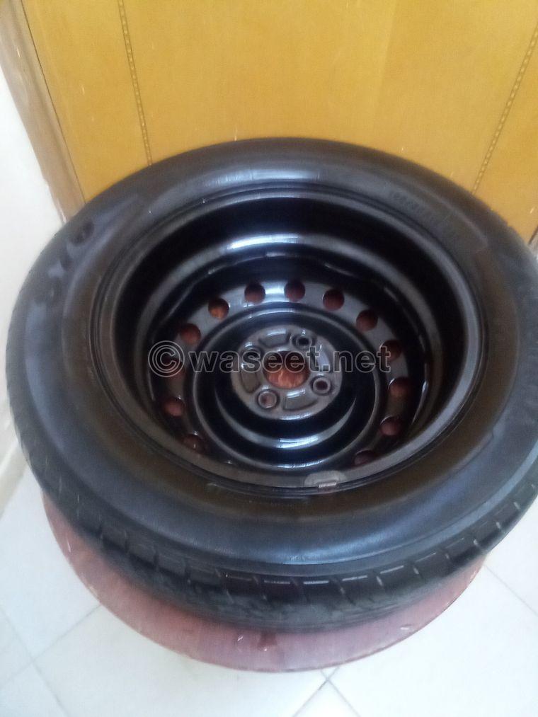 A tire with a rim for sale. The price is 50 dirhams  3