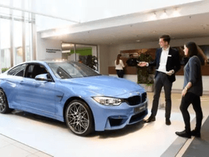 A salesman is required to work in a car showroom